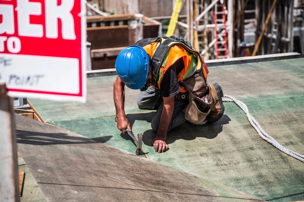 Injured warehouse worker being helped by a coworker after a workplace accident in Virginia